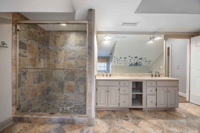 bathroom featuring vanity and a shower with door