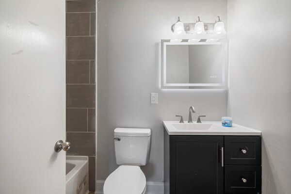 1918 Watkins Dr, Columbus, GA 31907 - full bathroom with vanity, toilet, and  shower combination