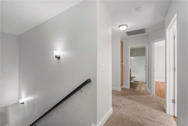 165 Wellman Dr, Phenix City, AL 36867 - corridor with light carpet, an upstairs landing, visible vents, and baseboards
