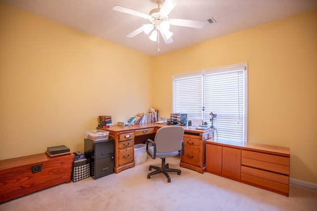 carpeted home office with ceiling fan