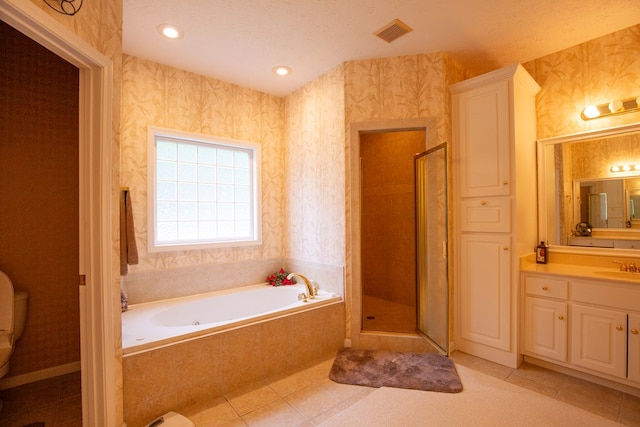 full bathroom featuring vanity, tile patterned floors, toilet, a textured ceiling, and independent shower and bath