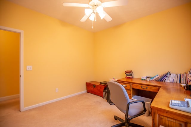 carpeted home office featuring ceiling fan