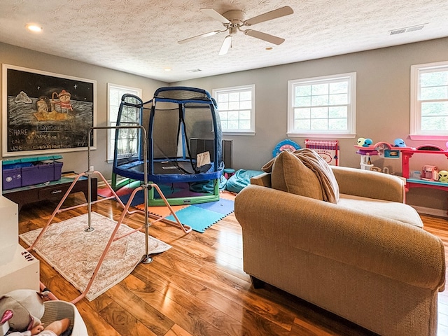 4880 Turnberry Ln, Columbus, GA 31909 - rec room featuring wood finished floors, healthy amount of natural light, a textured ceiling, a ceiling fan, and recessed lighting