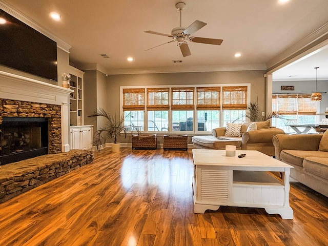 4880 Turnberry Ln, Columbus, GA 31909 - living room with crown molding, ceiling fan, wood finished floors, recessed lighting, and a stone fireplace