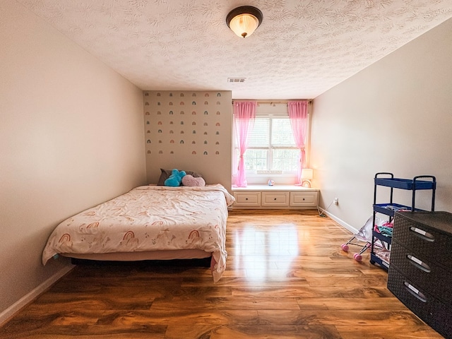 4880 Turnberry Ln, Columbus, GA 31909 - bedroom featuring light wood-style flooring and a textured ceiling