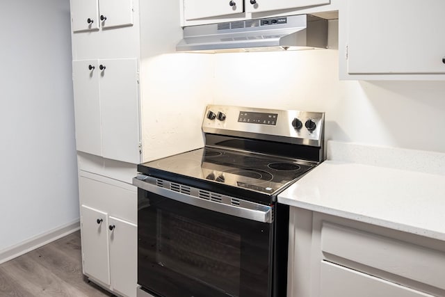 2104 Wellborn Dr, Columbus, GA 31907 - kitchen with electric stove, under cabinet range hood, white cabinetry, and light countertops