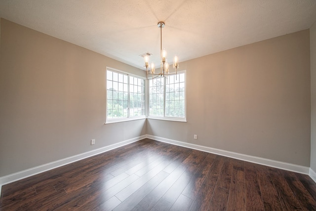 2027 Preston Dr, Columbus, GA 31906 - unfurnished room featuring a chandelier, baseboards, and dark wood finished floors