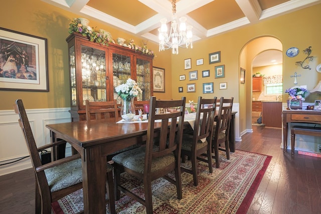 dining space with beamed ceiling, dark wood-type flooring, arched walkways, coffered ceiling, and a notable chandelier