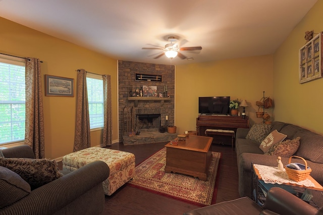 living area with ceiling fan, a fireplace, wood finished floors, and a wealth of natural light