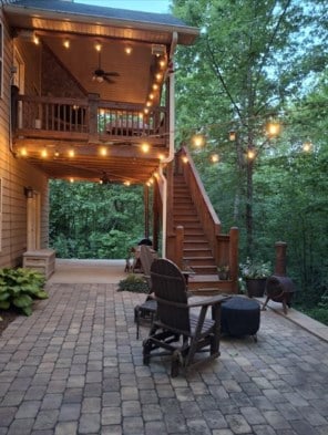 view of patio featuring a ceiling fan and stairs