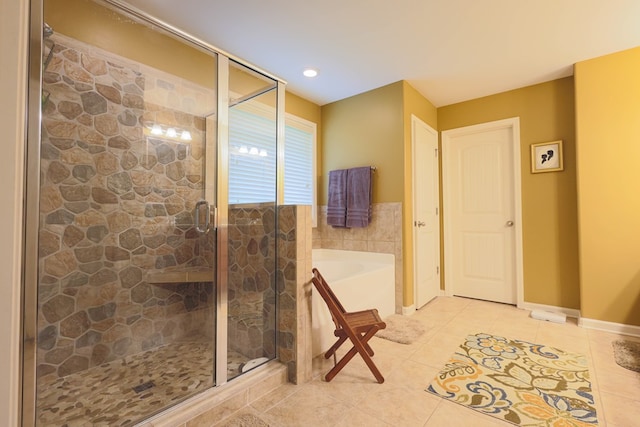 bathroom featuring tile patterned floors, a shower stall, and a bath
