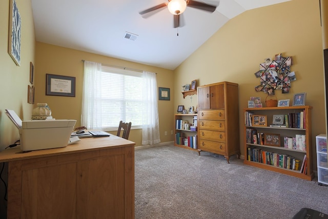 office space featuring visible vents, lofted ceiling, baseboards, ceiling fan, and light colored carpet