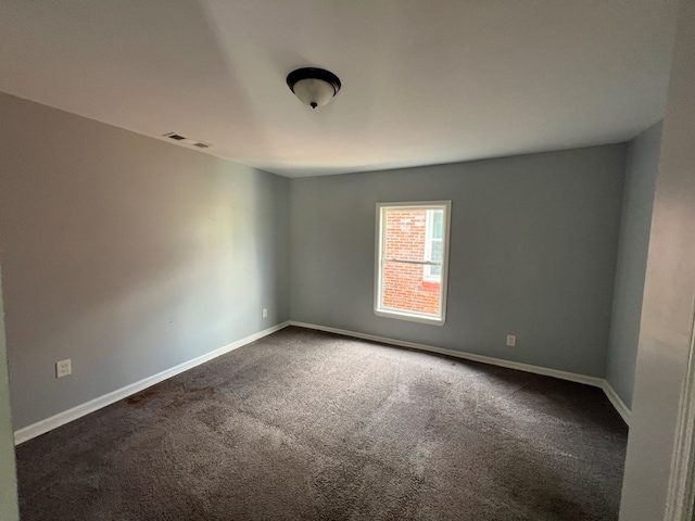 4261 Meritas Dr, Columbus, GA 31904 - spare room featuring dark colored carpet, baseboards, and visible vents