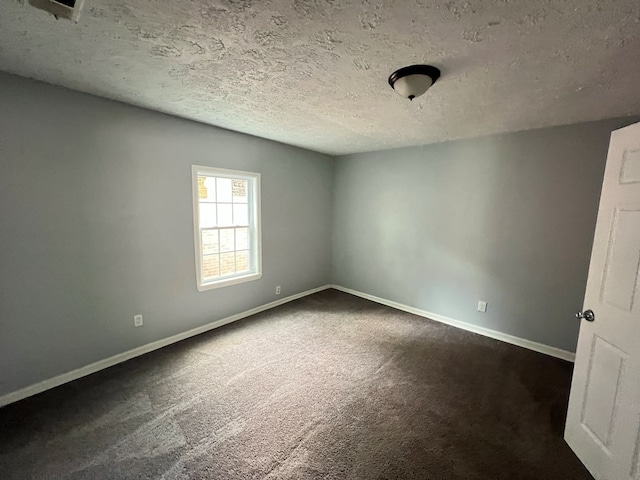 4261 Meritas Dr, Columbus, GA 31904 - spare room featuring baseboards, a textured ceiling, and dark carpet