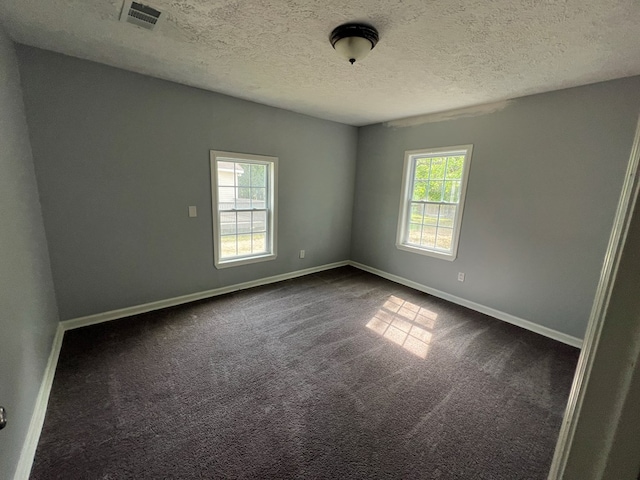 4261 Meritas Dr, Columbus, GA 31904 - unfurnished room featuring a healthy amount of sunlight, baseboards, dark colored carpet, and visible vents