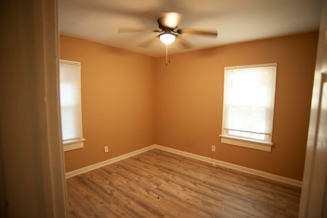 unfurnished room with ceiling fan and wood-type flooring