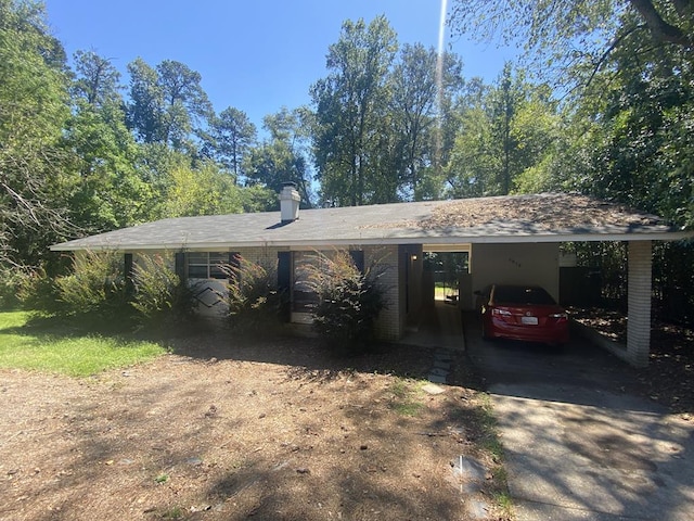 ranch-style home featuring a carport