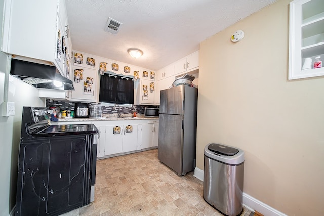 1605 39th St, Columbus, GA 31904 - kitchen with freestanding refrigerator, electric range oven, exhaust hood, light countertops, and white cabinets