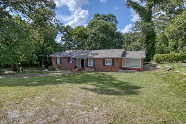 3775 Steam Mill Rd, Columbus, GA 31906 - ranch-style house featuring brick siding, a front lawn, view of wooded area, and a chimney
