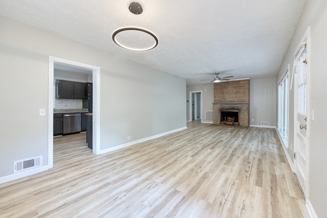3775 Steam Mill Rd, Columbus, GA 31906 - unfurnished living room with a ceiling fan, light wood-style flooring, and a large fireplace