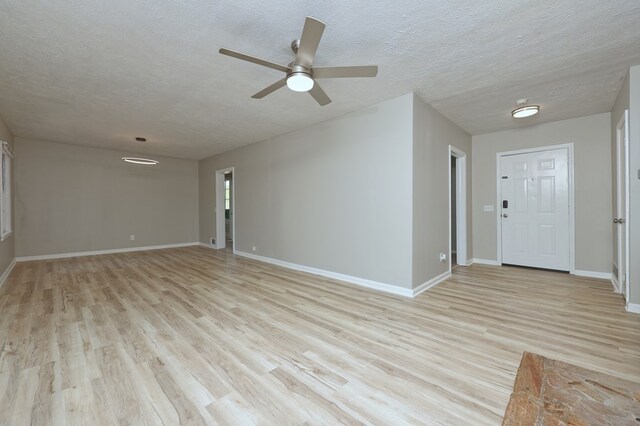 3775 Steam Mill Rd, Columbus, GA 31906 - unfurnished living room featuring light wood finished floors, ceiling fan, and a textured ceiling