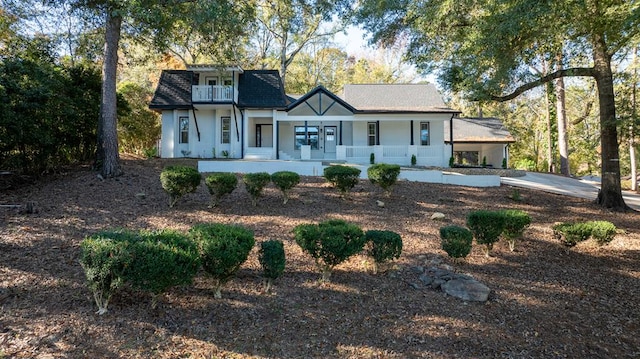 view of front of property featuring a porch and a balcony