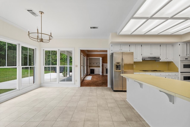 1425 Dartmouth Rd, Columbus, GA 31904 - kitchen featuring white appliances, under cabinet range hood, crown molding, a chandelier, and light countertops