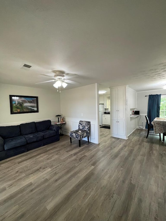 1023 Maridele Dr, Columbus, GA 31904 - living area featuring wood finished floors, ceiling fan, and wainscoting
