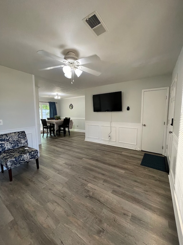 1023 Maridele Dr, Columbus, GA 31904 - living room with ceiling fan, a decorative wall, dark wood-style floors, and wainscoting