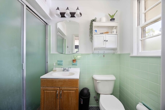 2618 Habersham Ave, Columbus, GA 31906 - bathroom with vanity, tile walls, a shower with shower door, and wainscoting