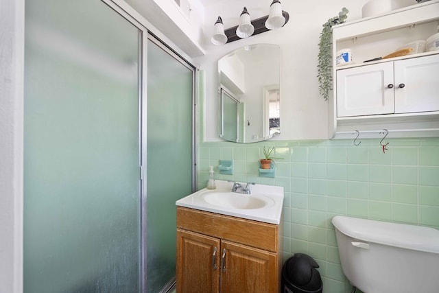2618 Habersham Ave, Columbus, GA 31906 - bathroom with vanity, a shower with shower door, and tile walls