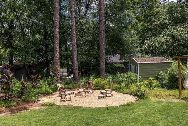 2618 Habersham Ave, Columbus, GA 31906 - view of grassy yard with an outdoor fire pit and a storage shed