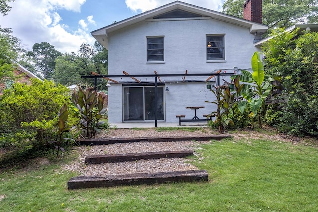 2618 Habersham Ave, Columbus, GA 31906 - back of house featuring brick siding, a chimney, and a yard