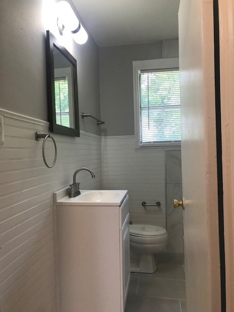 bathroom with tile patterned floors, vanity, and toilet