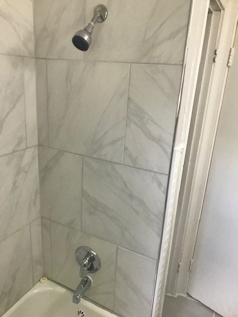 details with tiled shower / bath combo