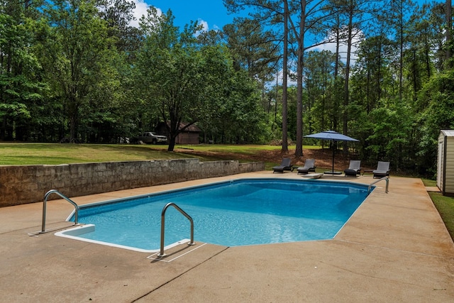 outdoor pool with a patio and a lawn