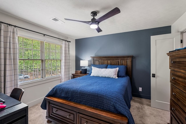 bedroom with baseboards, ceiling fan, carpet flooring, and visible vents