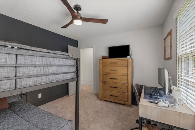 bedroom with a ceiling fan and light carpet