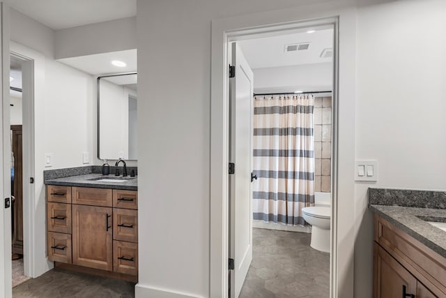full bathroom featuring toilet, visible vents, and vanity