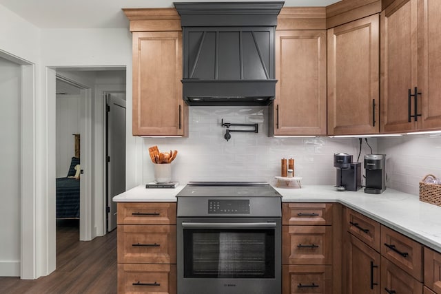 kitchen with premium range hood, tasteful backsplash, stainless steel electric stove, and dark wood-type flooring