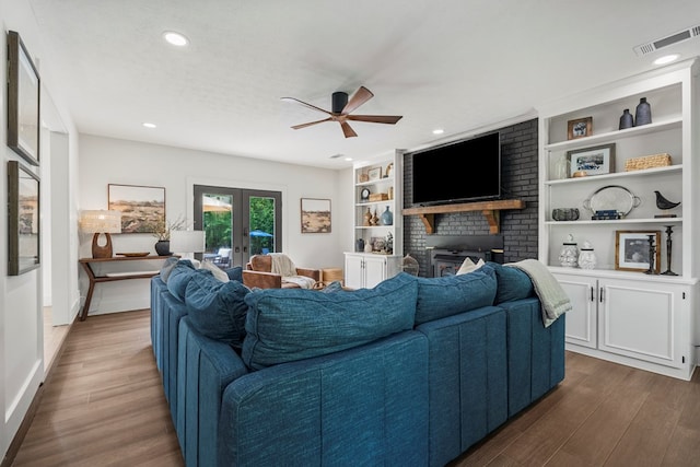 living area featuring visible vents, recessed lighting, a fireplace, ceiling fan, and dark wood-style flooring