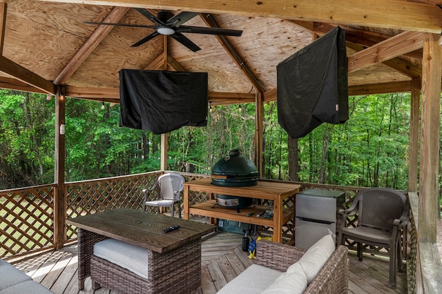 wooden terrace featuring a ceiling fan and outdoor dining area