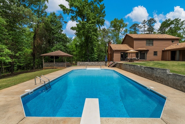 outdoor pool featuring a diving board, a gazebo, a lawn, and a patio area