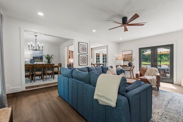 living room featuring french doors, dark wood-style flooring, ceiling fan with notable chandelier, and recessed lighting