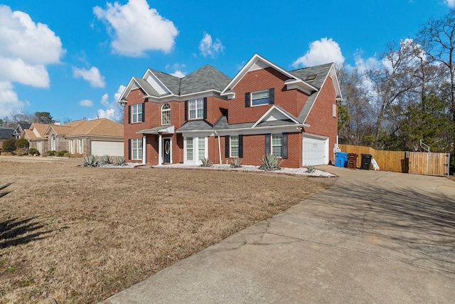 view of front of home with a garage and a front lawn