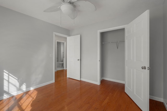 unfurnished bedroom featuring ceiling fan, a closet, and wood-type flooring