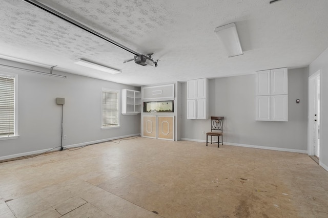 interior space with a textured ceiling and a healthy amount of sunlight