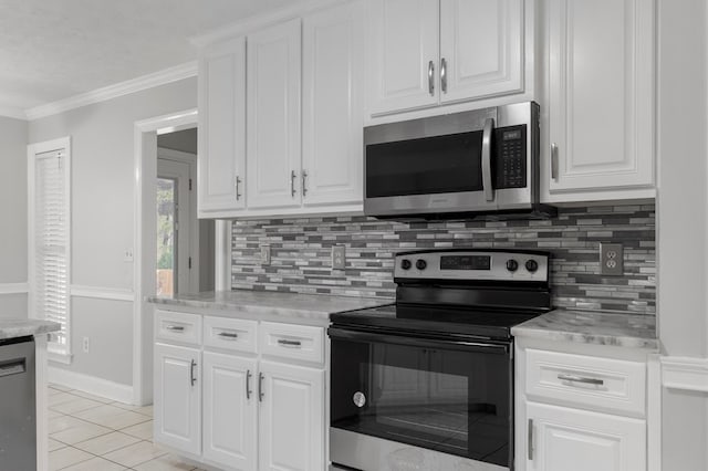 kitchen with range with electric cooktop, white cabinets, light tile patterned floors, backsplash, and crown molding