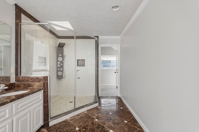 bathroom with a textured ceiling, vanity, ornamental molding, and a shower with shower door