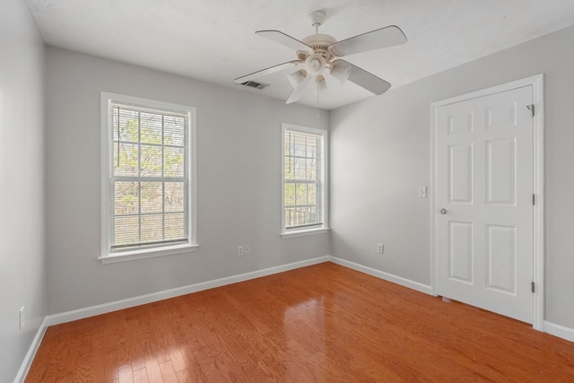 spare room featuring ceiling fan and hardwood / wood-style flooring